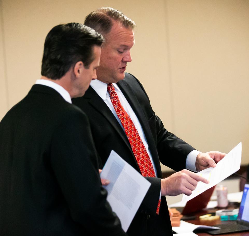 Assistant State Attorney Rich Buxman, left, talks with Executive Assistant Public Defender John Spivey