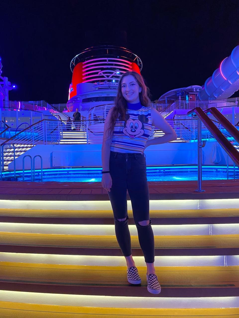 Reporter Amanda Krause on the Disney Wish cruise ship at night.