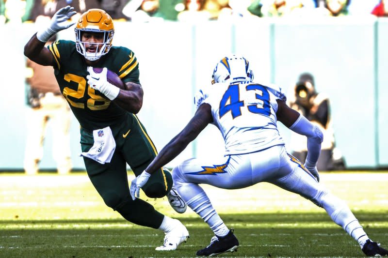 Green Bay Packers running back A.J. Dillon (L) runs against the Los Angeles Chargers on Sunday at Lambeau Field in Green Bay, Wis. Photo by Tannen Maury/UPI