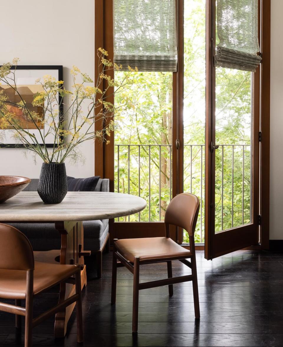 Paquette transformed the client’s heirloom dining table to fit the small space, adding a travertine top to create greater contrast with the hand-made base