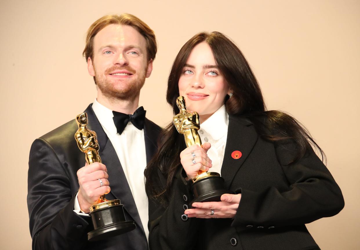 Finneas O'Connell, left, and Billie Eilish pose with the Oscars backstage at the Dolby Theatre.
