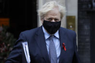 Britain's Prime Minister Boris Johnson leaves Downing Street to attend Parliament in London, Tuesday, Dec. 1, 2020. Members of Parliament will vote later Tuesday on the proposed tier system as the country prepares to come out of lockdown. (AP Photo/Kirsty Wigglesworth)