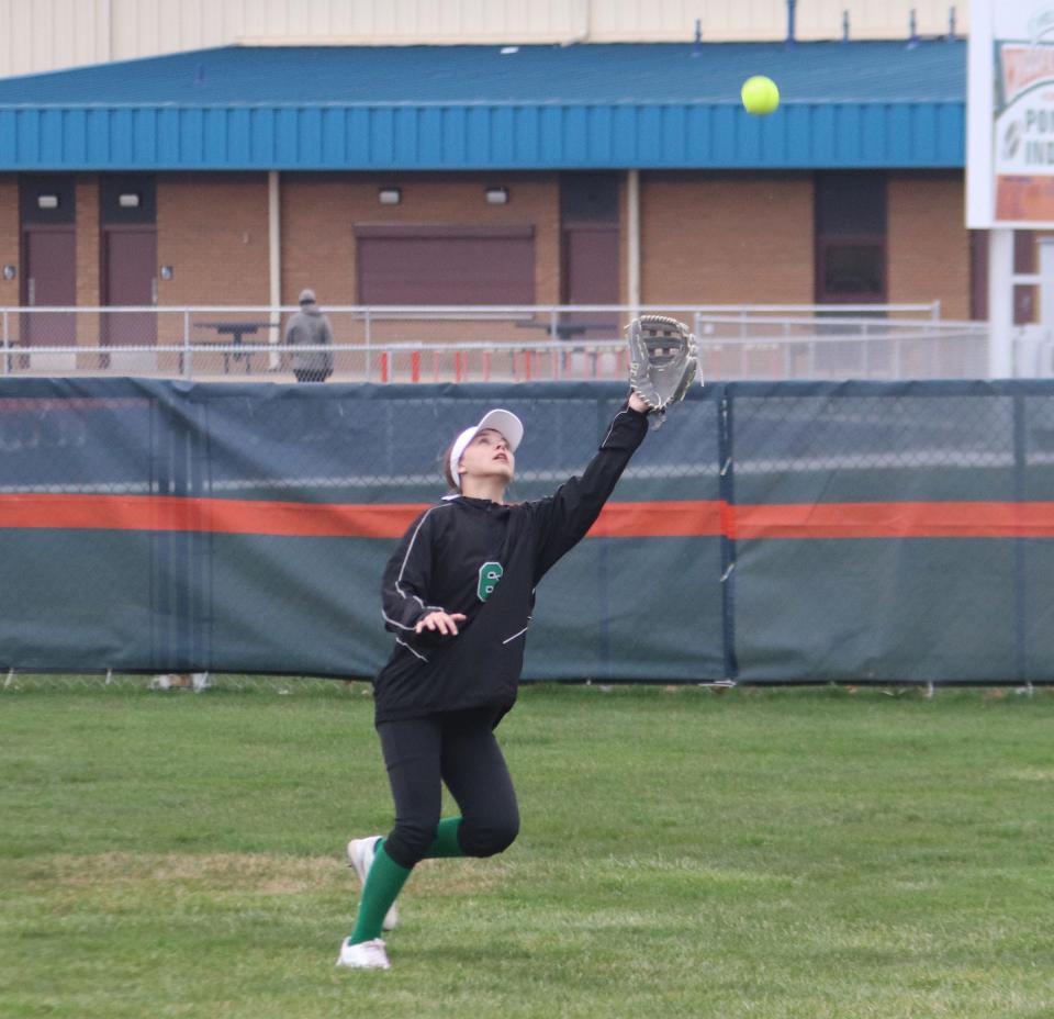 Dwight right fielder Mikayla Ely tries to track down a fly ball during Monday's game with Pontiac.