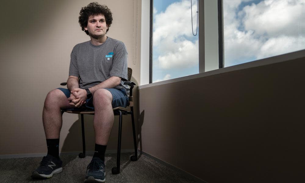 sam bankman friend sitting on a chair by a window