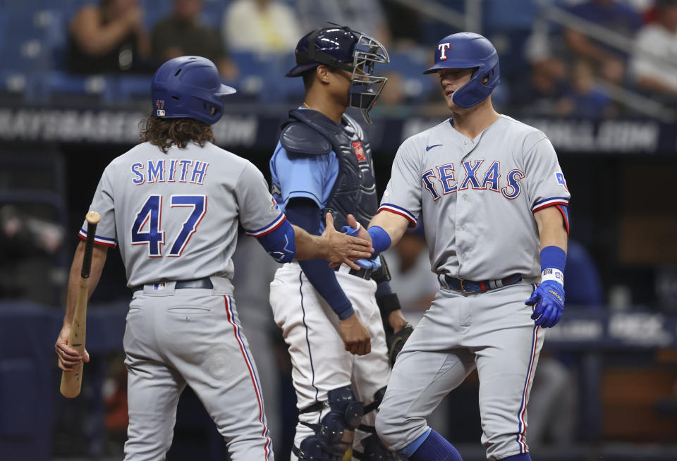Texas Rangers' Josh Jung, right celebrates with teammate Josh Smith (47) after hitting a solo home run in the second inning of a baseball game against the Tampa Bay Rays, Sunday, Sept. 18, 2022, in St. Petersburg, Fla. (AP Photo/Mark LoMoglio)