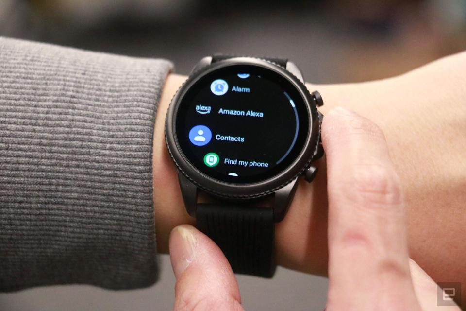 The Razer x Fossil Gen 6 smartwatch with black straps on a wrist, showing a list of apps including one called 