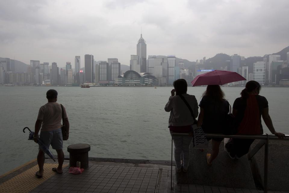 People rest by Tsim Sha Tsui waterfront hours before Typhoon Usagi is expected to make landfall, in Hong Kong