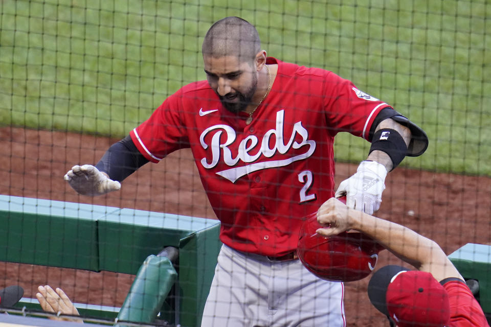 Cincinnati Reds' Nick Castellanos celebrates as he returns to the dugout after hitting a solo home run off Pittsburgh Pirates starting pitcher Steven Brault during the fifth inning of the first of two baseball games in Pittsburgh, Friday, Sept. 4, 2020. (AP Photo/Gene J. Puskar)