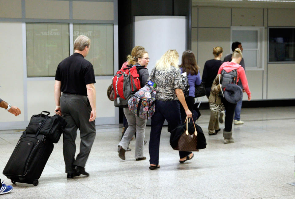 The Knox family head for a plane at Rome's Leonardo da Vinci airport that will take them back to Seattle after a lay-off at London Heathrow.