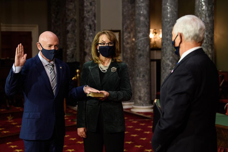 Vice President Mike Pence swears in Senator Mark Kelly as Gabrielle Giffords holds the Bible.