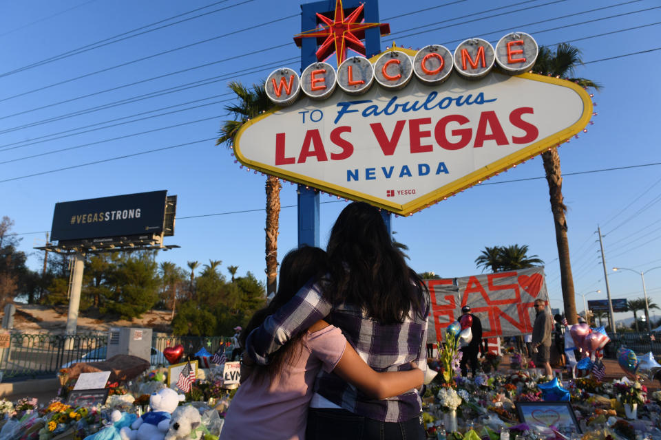 People visit a makeshift memorial to the victims of the Oct. 1, 2017,&nbsp;massacre at an outdoor concert in Las Vegas. The gunman&nbsp;had several semiautomatic weapons. (Photo: The Washington Post via Getty Images)