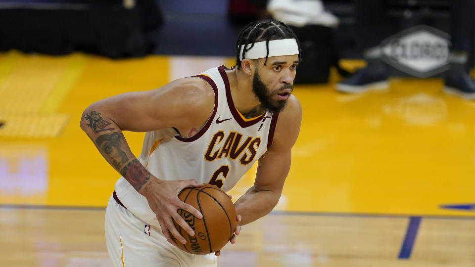 JaVale McGee holds the basketball in both hands during a game.