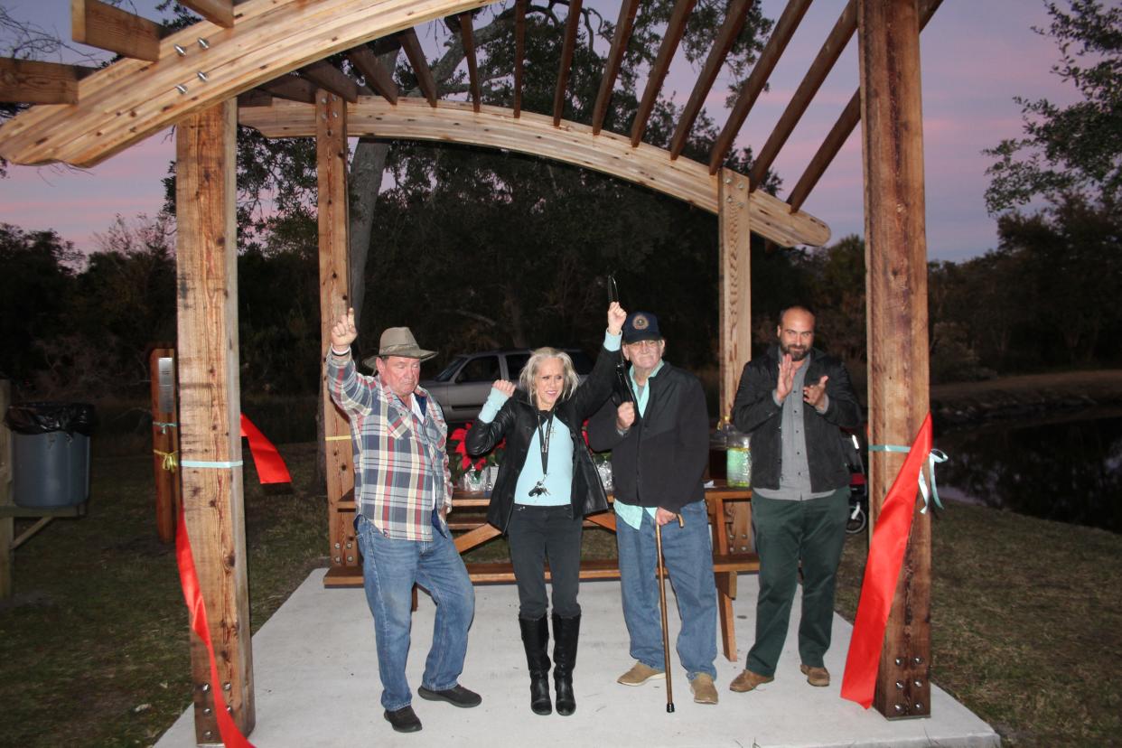 John Bennett (from left), along with his sister, Jayne Bohannon and older brother, F. Reuben Bennett Jr., join with John November, executive director of the Public Trust for Conservation, in cutting the ribbon for Bennett’s Wave Pergola, named in honor of Sara Bennett and Fenis Reuben Bennett, Sr.