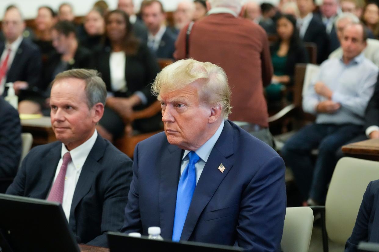 Former President Donald Trump, right, sits in the courtroom at New York Supreme Court, Monday 2 October 2023 (AP)