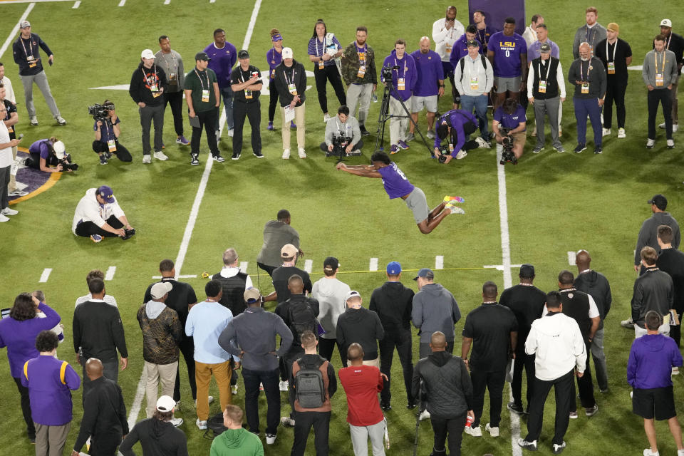 LSU wide receiver Gregory Clayton Jr. performs the broad jump during LSU's NCAA football pro day in Baton Rouge, La., Wednesday, March 27, 2024. (AP Photo/Gerald Herbert)
