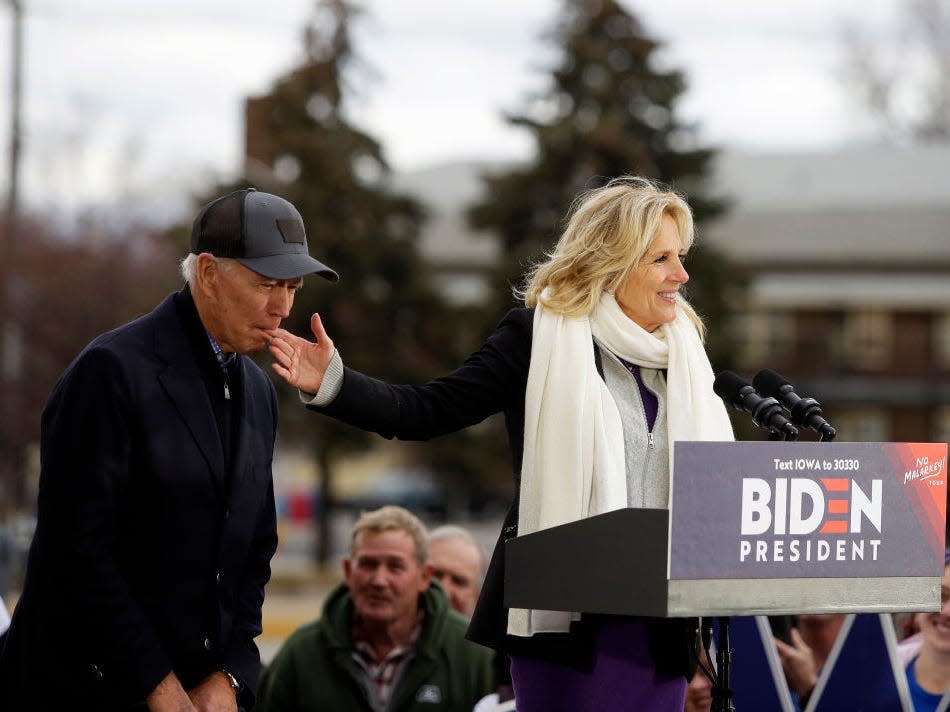 Joe Biden bites Jill Biden's finger as she speaks at a campaign event