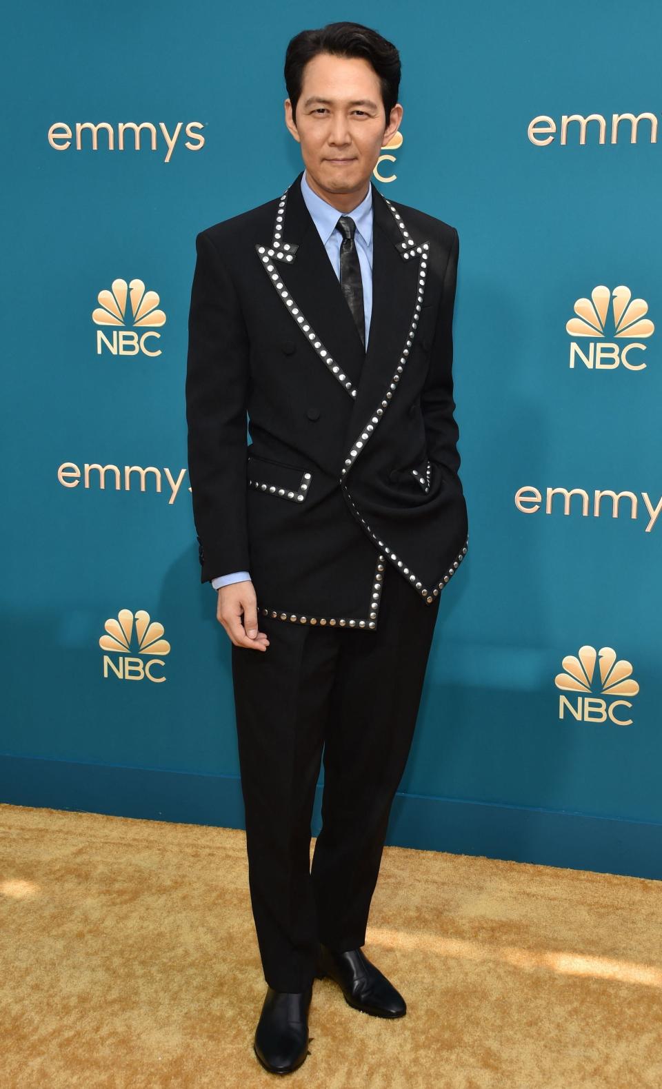 wearing a suit with studs lining the edges of the coat