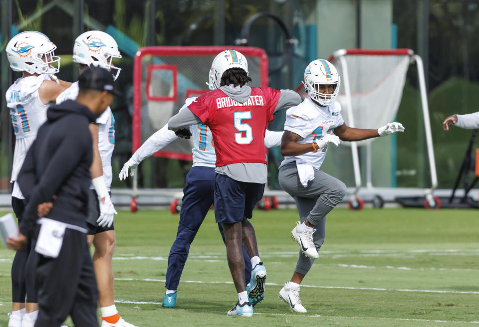 Miami Dolphins quarterback Teddy Bridgewater (5) interacts with teammate Jaylen Waddle (17) during practice at Baptist Health Training Complex in Hard Rock Stadium on Wednesday, Dec. 28, 2022 in Miami Gardens, Fla. (David Santiago/Miami Herald via AP)