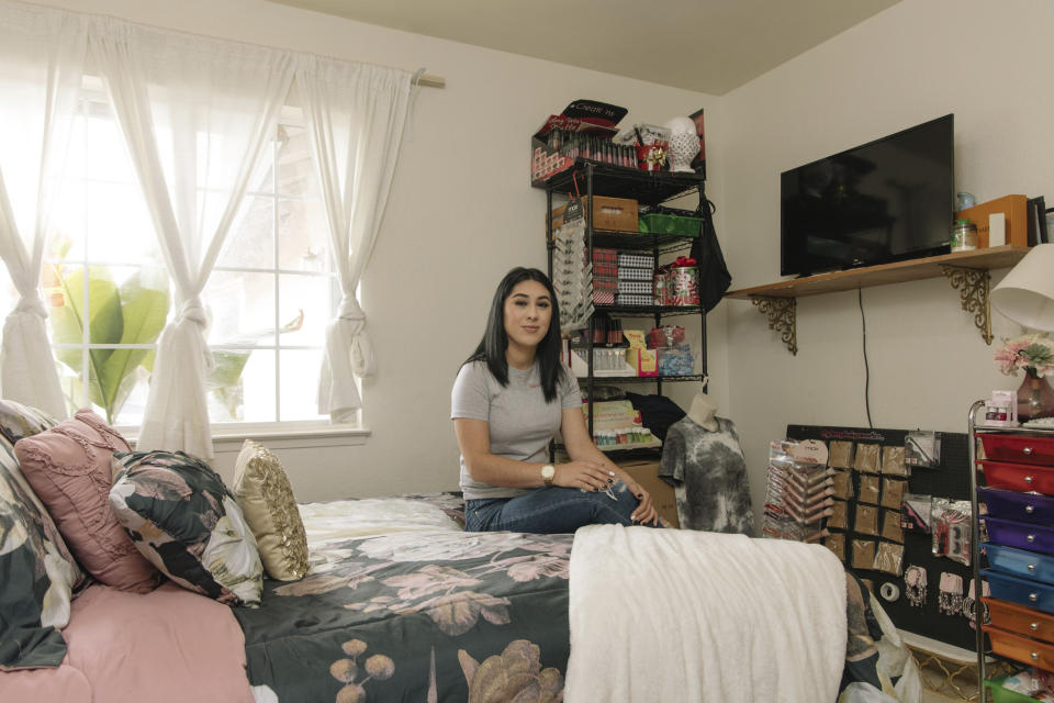 Alexandra Orozco sits in her bedroom where she runs her beauty company, Glossy Baby Cosmetics, in Delano, Calif., on Sunday, Dec. 6, 2020. She’s currently making an estimated $200-300 per month in sales from her new online business, nearly five times less than her salary at J.C. Penney. (Madeline Tolle/The Fuller Project via AP)