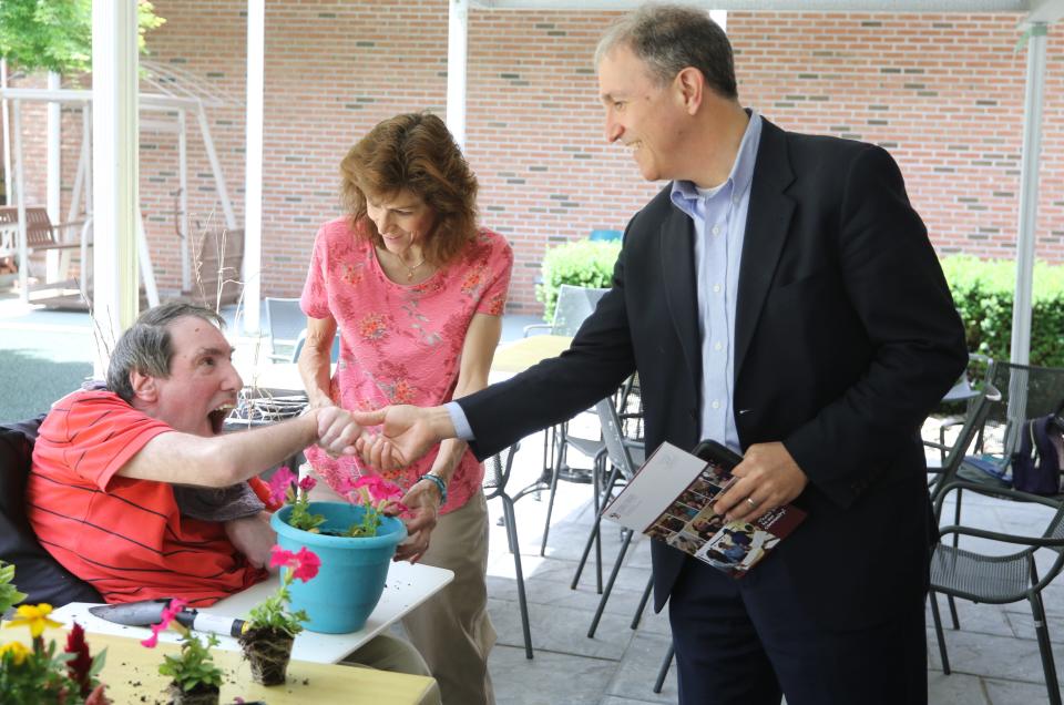 Former Ridgewood Mayor Paul Aronsohn was appointed by Gov Murphy as the state's first Ombudsman for Individuals with Intellectual or Developmental Disabilities and their Families. Here on a tour of the Eastern Christian Children's Retreat, a non-profit agency caring for adults with intellectual and developmental disabilities he meets with a resident and Laura Lupica, in charge of recreational aides at the facility. 