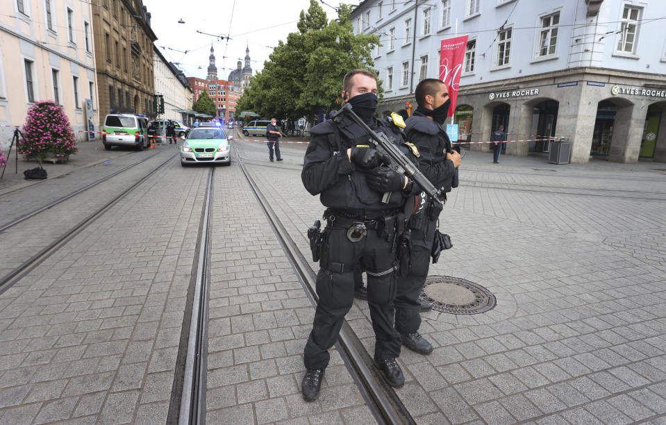 Police cars attend the scene of an incident in Wuerzburg, Germany, Friday June 25, 2021. German police say several people have been killed and others injured in a knife attack in the southern city of Wuerzburg on Friday. (Karl-Josef Hildenbrand/dpa via AP)