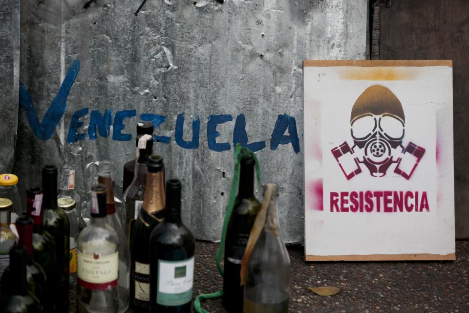 Items allegedly seized by the Bolivarian National Guard from demonstrators at Plaza Altamira after taking control of it, in Caracas, Venezuela, Monday, March 17, 2014. Government security forces took control of a Caracas plaza and surrounding neighborhoods Monday morning that had become the center of student-led protests. The poster reads in Spanish "Resistance". Clusters of National Guardsmen were a visible presence not only on Plaza Altamira, but along the principal streets extending from it in the municipality of Chacao. (AP Photo/Esteban Felix)
