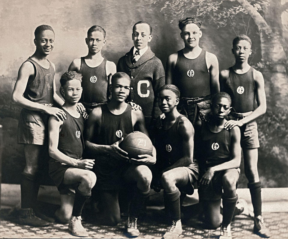 An African American team stands for a team photo