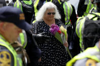 <p>Susan Bro (C), mother of Heather Heyer, arrives at a makeshift memorial for her daughter Heather who was killed one year ago during a deadly clash, August 12, 2018 in Charlottesville, Virginia. Charlottesville has been declared in a state of emergency by Virginia Gov. Ralph Northam as the city braces for the one year anniversary of the deadly clash between white supremacist forces and counter protesters over the potential removal of Confederate statues of Robert E. Lee and Jackson. A ‘Unite the Right’ rally featuring some of the same groups is planned for today in Washington, DC. (Photo: Win McNamee/Getty Images) </p>