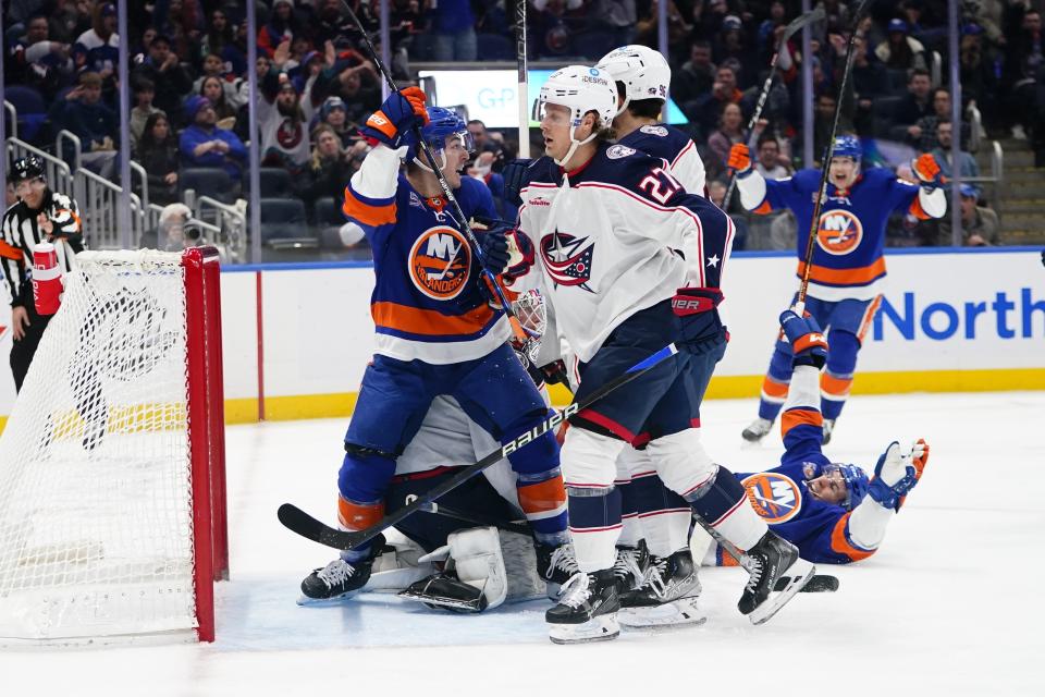 New York Islanders' Jean-Gabriel Pageau, left, celebrates his goal as Columbus Blue Jackets' Adam Boqvist (27) reacts during the second period of an NHL hockey game Thursday, Dec. 29, 2022, in Elmont, N.Y. (AP Photo/Frank Franklin II)