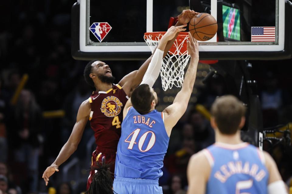 Cavaliers forward Evan Mobley elevates above the basket to block a shot by Clippers center Ivica Zubac.