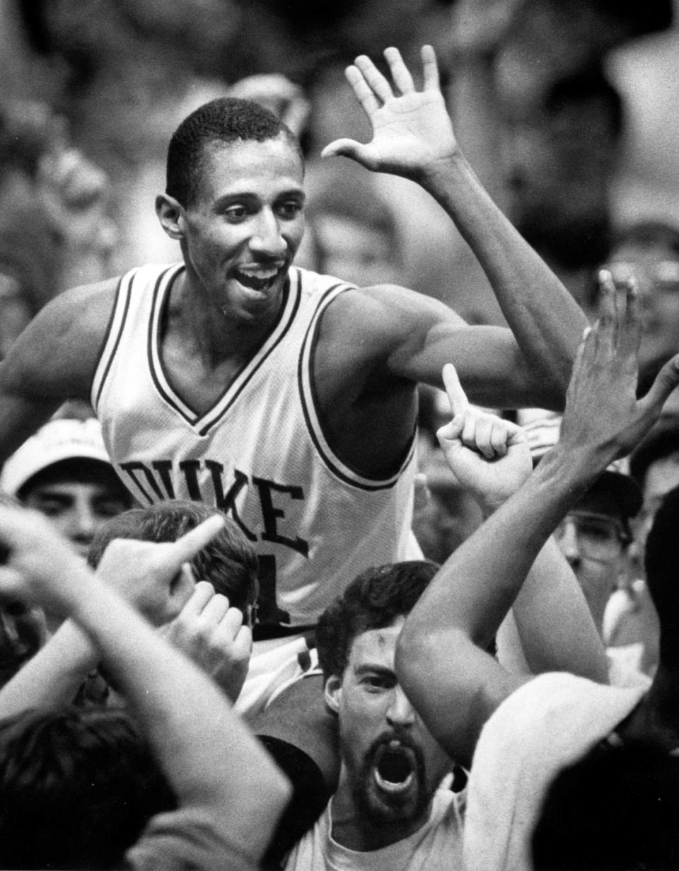 Duke point guard Johnny Dawkins rides on the shoulders of a Duke fan after the Blue Devils defeated Georgia Tech 68-67 to win the ACC basketball tournament March 9, 1986 in Greensboro, NC.