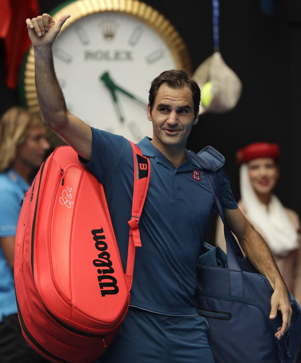 Switzerland's Roger Federer waves as he leaves Rod Laver Arena after defeating Britain's Daniel Evans in their second round match at the Australian Open tennis championships in Melbourne, Australia, Wednesday, Jan. 16, 2019. (AP Photo/Mark Schiefelbein)