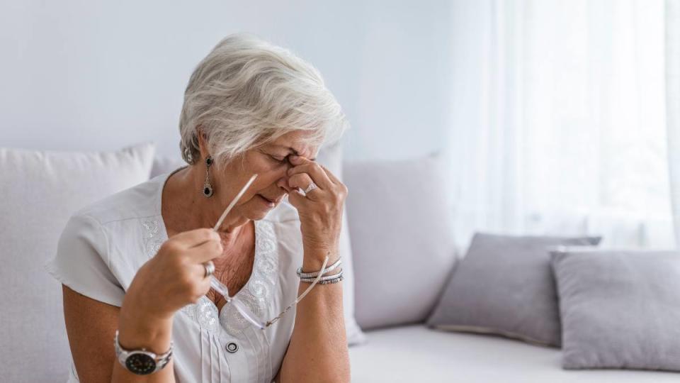 best foods for hangover: Elderly woman suffering from headache at home