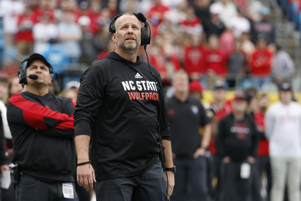 FILE - North Carolina State head coach Dave Doeren watches a replay as his team plays against Maryland in the Duke's Mayo Bowl NCAA college football game in Charlotte, N.C., Dec. 30, 2022. N.C. State opens the season at Connecticut on Aug. 31, 2023. (AP Photo/Nell Redmond, File)