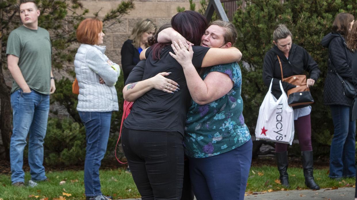 People evacuated from the Boise Towne Square shopping mall await news after a man opened fire in the mall Monday, Oct. 25, 2021, in Boise, Idaho. (Darin Oswald/Idaho Statesman via AP)