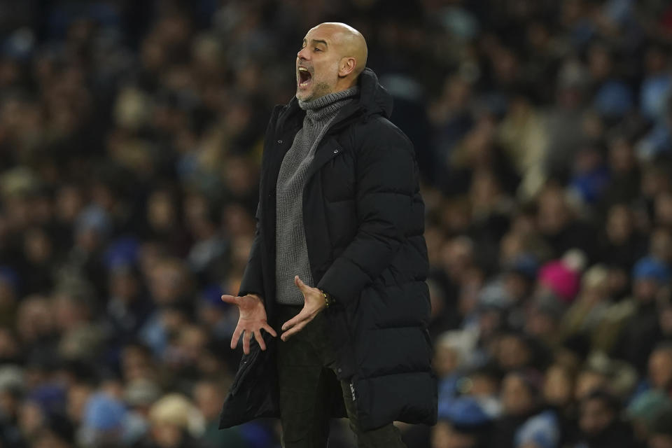 Manchester City's head coach Pep Guardiola reacts during the English FA Cup soccer match between Manchester City and Chelsea at the Etihad Stadium in Manchester, England, Sunday, Jan. 8, 2023. (AP Photo/Dave Thompson)