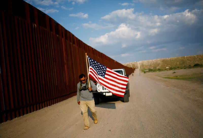 FILE PHOTO: Military veterans walk on the border between the U.S. and Mexico to request their return to the United States, in Sunland Park