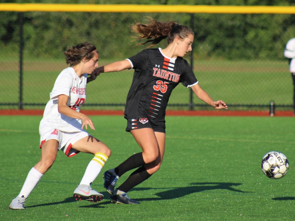 Taunton's Cali Melo jostles past New Bedford's Jenna Nogueira for the ball during a non-league game.