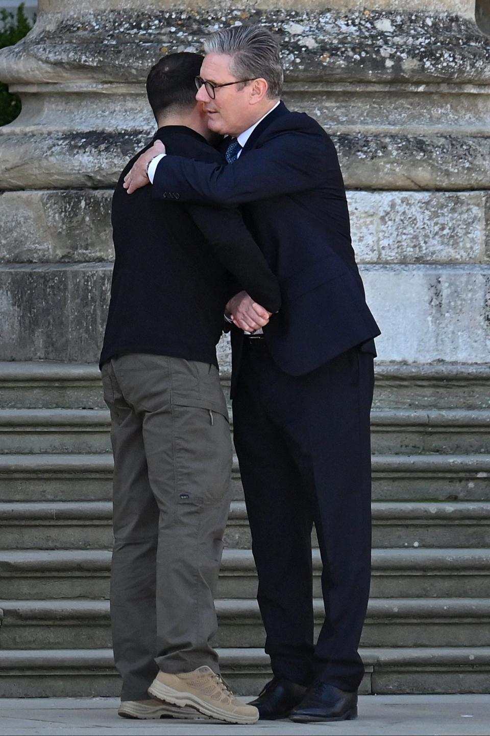 Ukrainian president Volodymyr Zelensky and British prime minister Sir Keir Starmer embrace in the grand entrance of Blenheim Palace (AFP via Getty Images)