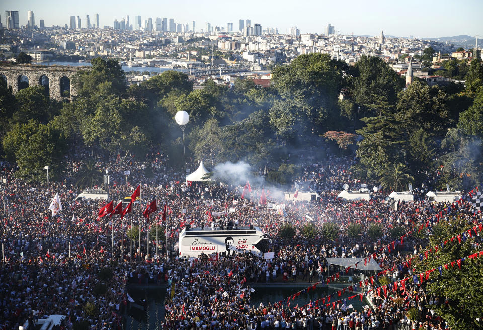 Thousands of supporters surround a bus from where Ekrem Imamoglu, the new Mayor of Istanbul from Turkey's main opposition opposition Republican People's Party (CHP) makes a speech after he took over office, in Istanbul, Thursday, June 27, 2019. Imamoglu is formally taking office as mayor of Istanbul four days after he won a repeat election in Turkey's largest city and commercial hub. (AP Photo/Lefteris Pitarakis)