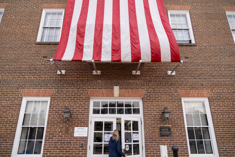 A woman enters a voting polling place at Alexandria City Hall, in Alexandria, Va., Tuesday, Nov. 7, 2023. (AP Photo/Jacquelyn Martin)