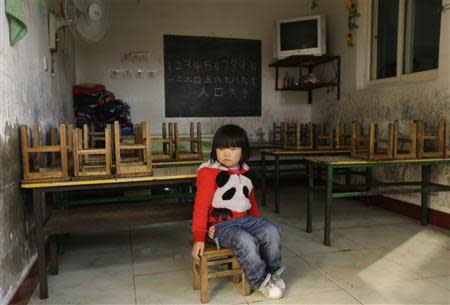 A girl sits on a chair in a class at a kindergarten, a school for children of migrant workers, on the outskirts of Beijing November 8, 2013. REUTERS/Jason Lee