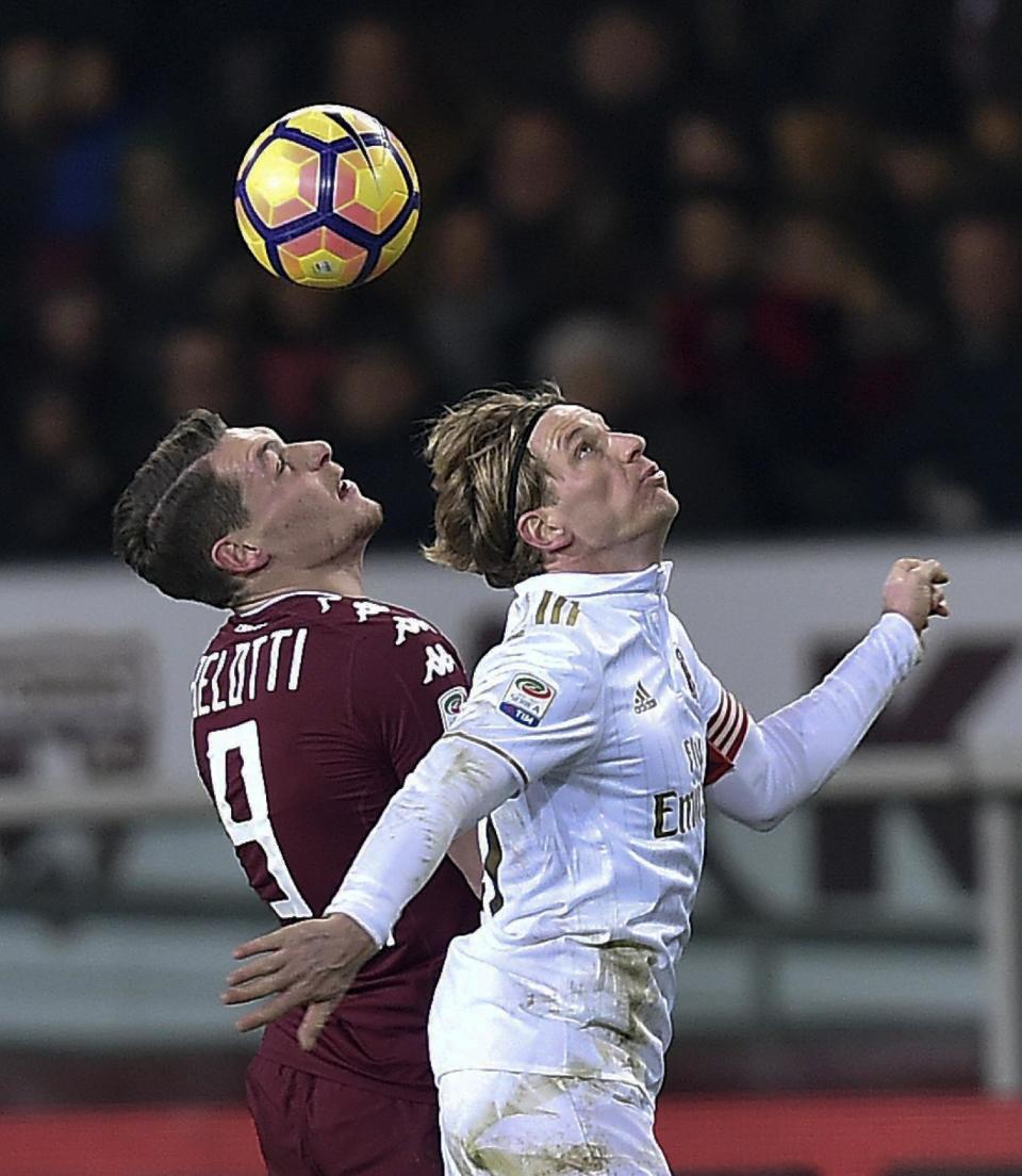 Torino's Andrea Belotti, left, and Milan's Ignazio Abate fight for the bal during a Serie A soccer match between Torino and Milan, at Turin's Olympic stadium, Italy, Monday, Jan. 16, 2017. (Alessandro Di Marco/ANSA via AP)