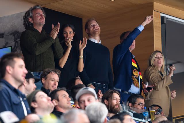 <p>Derek Cain/Getty</p> Meghan Markle and Prince Harry celebrate a Vancouver Canucks goal during the third period of the NHL game against the San Jose Sharks at Rogers Arena on November 20.