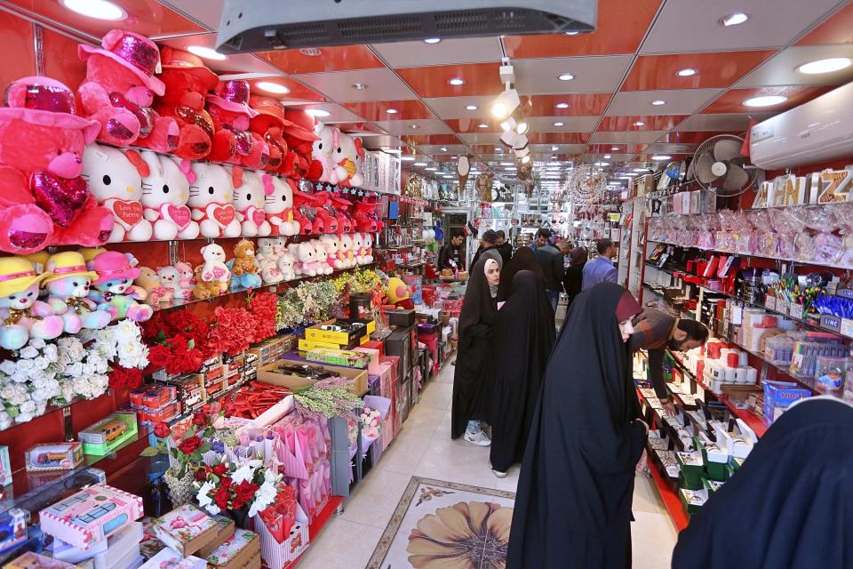 In this Thursday, Feb. 13, 2020 photo, people shop for Valentine's Day gifts in Najaf, Iraq. In recent years, Valentine's in Najaf has emerged as a field of contention. It pitted revelers who see in it harmless fun and personal freedom advocates against conservatives who view it as sacrilege--a foreign celebration that has no place in a holy city like Najaf. (AP Photo/Anmar Khalil)