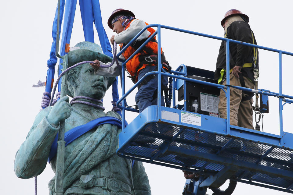 FILE - Crews remove the Confederate Soldiers & Sailors Monument in Libby Hill Park in Richmond, Va., on July 8, 2020. At least 63 Confederate statues, monuments or markers have been removed from public land across the country since George Floyd’s death on May 25, making 2020 one of the busiest years yet for removals, according to an Associated Press tally. (AP Photo/Steve Helber, File)