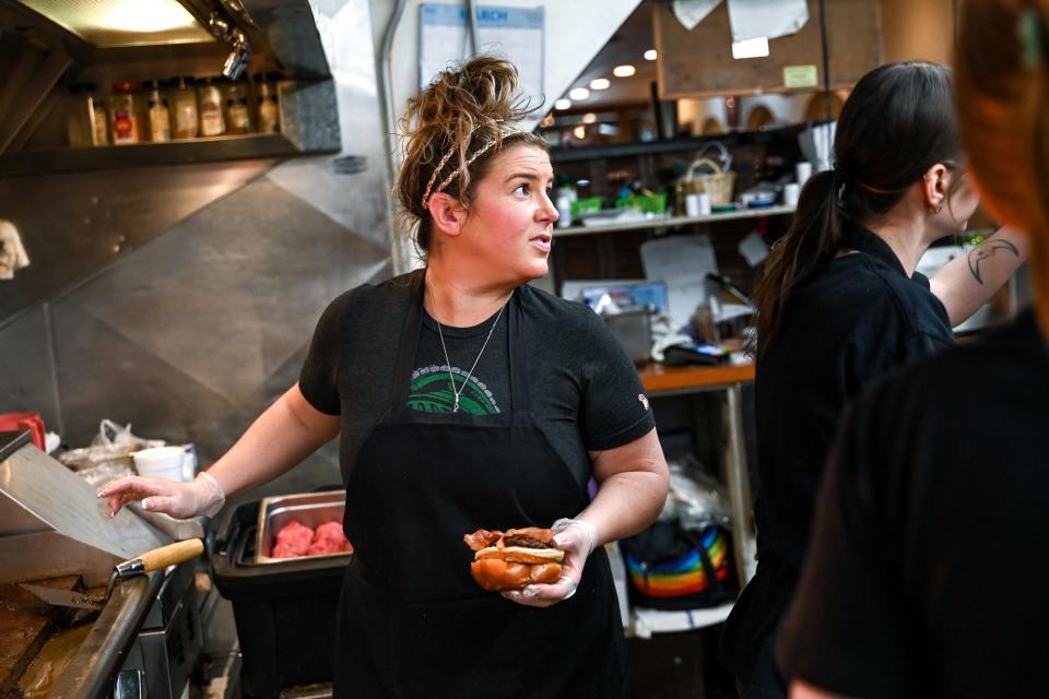 Autumn Weston works on an order in the kitchen at Weston's Kewpee Sandwich Shop on Thursday, March 16, 2023, in Lansing.