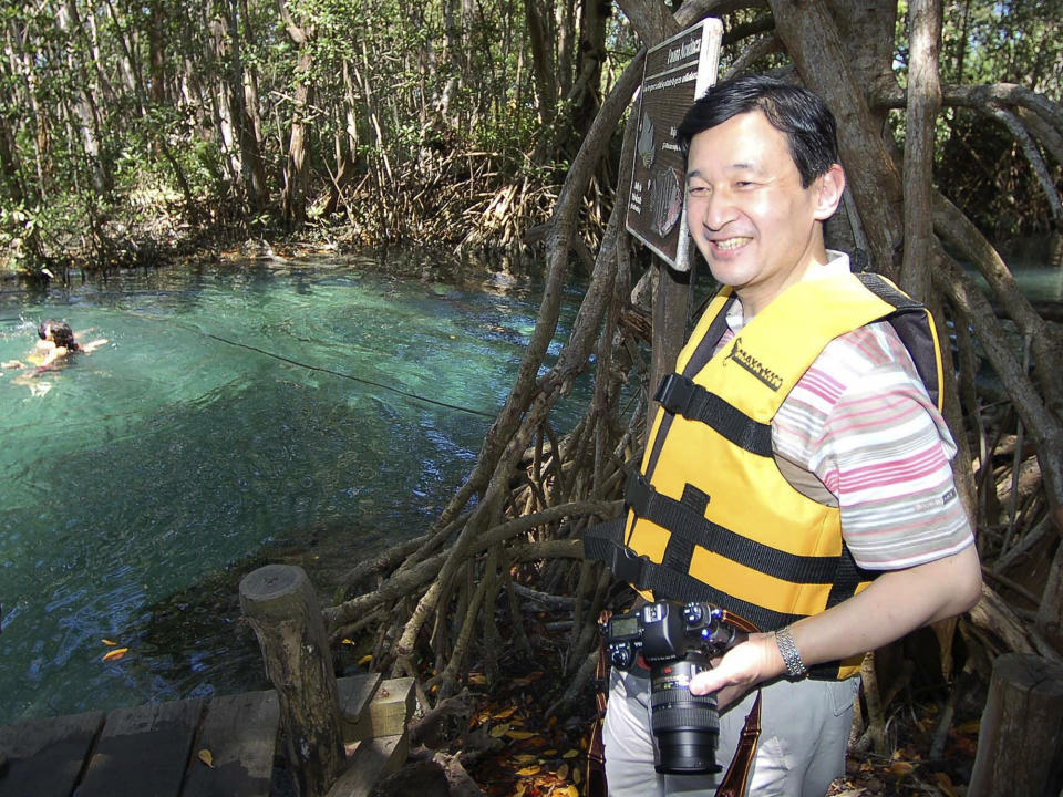 FILE - In this March 19, 2006, file photo, Japan's Crown Prince Naruhito looks out over a cenote, or sinkhole, during a visit to Celestun, Mexico. Crown Prince Naruhito is in Mexico to attend the World Water Forum in Mexico City. Naruhito, 59, will be Japan’s first emperor to have studied abroad and will enjoy greater liberty in shaping his own role than his father. Palace watchers say that as emperor Naruhito might focus on global issues, including disaster prevention and water conservation. (AP Photo/Isreal Leal, File)