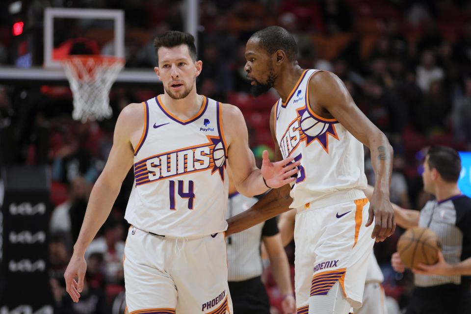 Jan 29, 2024; Miami, Florida, USA; Phoenix Suns forward Drew Eubanks (14) talks to forward Kevin Durant (35) against the Miami Heat during the first quarter at Kaseya Center.