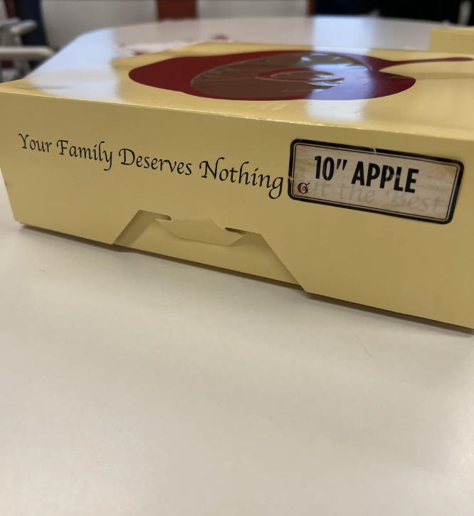 Pie box with humorous alteration saying "Your Family Deserves Nothing" instead of the original message